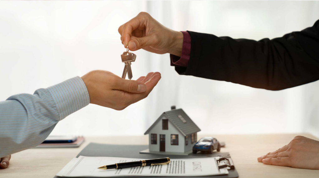 Professional mortgage planning scene - hand writing notes with miniature blue house model coins calculator coffee and laptop showing real estate budgeting